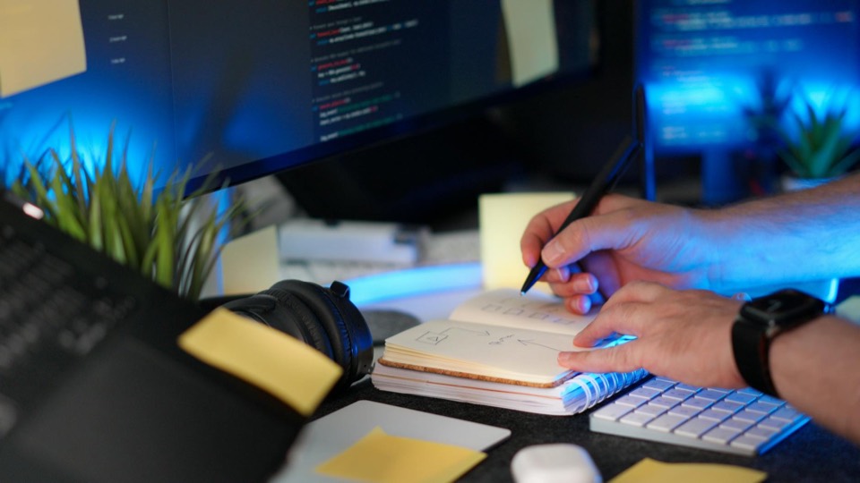 Desk with code, notes, and workflow planning
